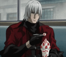 a man in a red jacket is eating a ice cream cone