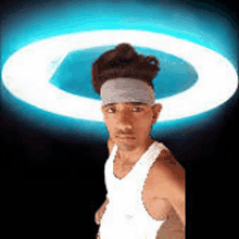 a man wearing a headband is standing in front of a light ring .