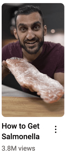 a man is holding a piece of salmon wrapped in plastic