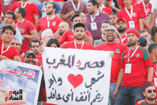 a man holds a sign that says " egypt and algeria "