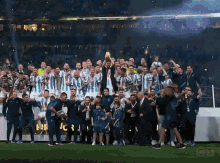 a group of soccer players are posing for a photo with a trophy and a sign that says ctv on it