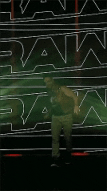 a man is dancing in front of a sign that says ran