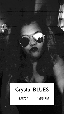 a black and white photo of a woman wearing sunglasses with a caption that says crystal blues