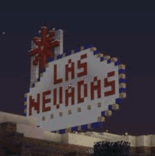 a sign that says las nevadas is sitting on top of a building at night .