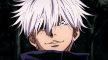 a man with white hair and blue eyes is smiling