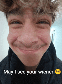 a young man with a mustache is smiling with the words may i see your wiener above him