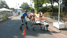 a group of people rollerblading on a street with a sign that says knl on it