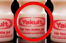 three bottles of yakult with a red circle around it