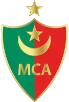 a green and red shield with the word mca in gold letters