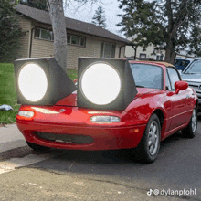 a red car with two speakers mounted to the front