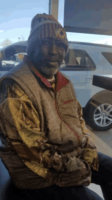 a man wearing a redskins jacket and a beanie