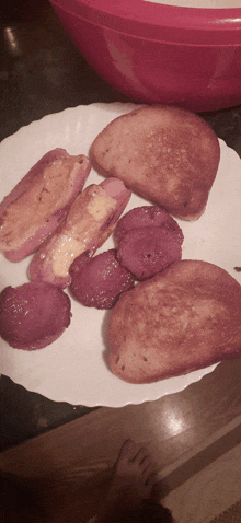 a white plate topped with a variety of food including hot dogs and french toast