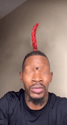 a man with a red wig on his head has a single eye