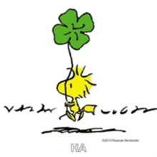 a cartoon of woodstock holding a green four leaf clover .