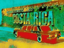 a red car is in front of a costa rica sign