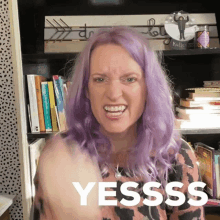 a woman with purple hair is making a funny face and says yesss