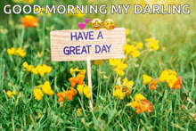 a wooden sign in a field of flowers says `` have a great day ''