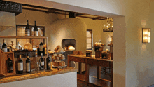 several bottles of wine are displayed on a counter in front of a fireplace