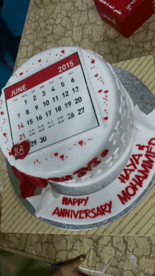 a cake with a calendar on it and the words happy anniversary