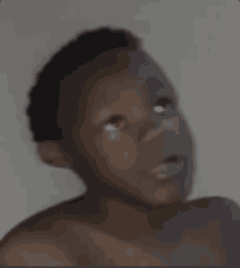 a blurred image of a child 's face with a white background