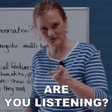 a woman in a blue and white striped shirt is pointing at the camera with the words " are you listening " above her