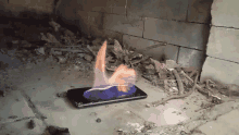 a cell phone is on fire in front of a wall