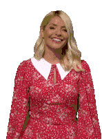 a woman in a red dress with a white collar smiles