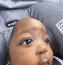 a close up of a baby 's face in a high chair .