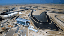 an aerial view of a race track with a building in the middle of it