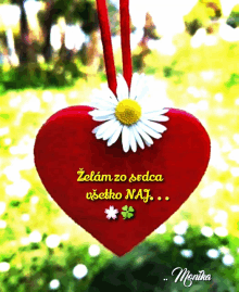 a red heart with a daisy hanging from it and the words " zelam zo srdca " on it