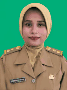 a woman in a military uniform has a name tag on her chest that says menteri bust pratama