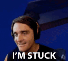 a man wearing headphones is saying `` i 'm stuck '' .