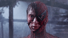 a man in a spiderman costume with blood on his face