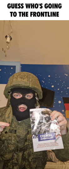 a man in a helmet and mask is holding a book that says " guess who 's going to the frontline "