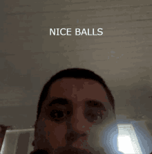 a close up of a man 's face with the words nice balls below it