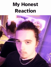 a picture of a man with a bow in his hair and the words " my honest reaction "