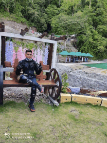 a man sitting on a bench with a sign that says saliway