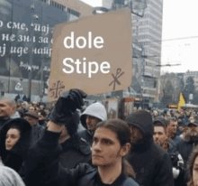 a man holds a sign that says dole stipe