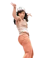 a woman in a tan tank top and orange pants dancing