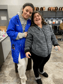 a woman wearing a blue jacket that says baker on it