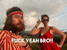 a man with a beard and a rainbow headband stands next to a woman in a red dress who says fuck yeah