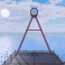 a large red object with a circle in the middle sits on a pier overlooking the ocean