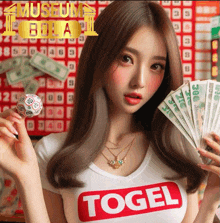 a woman wearing a t-shirt that says ' togel ' holds a ball and money