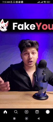 a man is sitting in front of a microphone with fake you written on the bottom