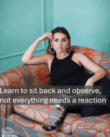 a woman sits on a couch with a quote that says learn to sit back and observe