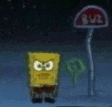 a spongebob squarepants character is standing in front of a bus stop at night .