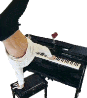 a person doing a handstand on top of a piano keyboard