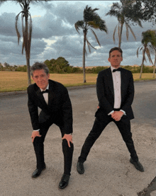 two men in tuxedos are posing for a photo