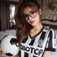 a woman holding a soccer ball wearing a shirt that says sbotop