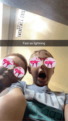 two young boys wearing sunglasses and a sign that says emergency exit